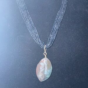 Elegant Multi-Strand Necklace with Stone Pendant